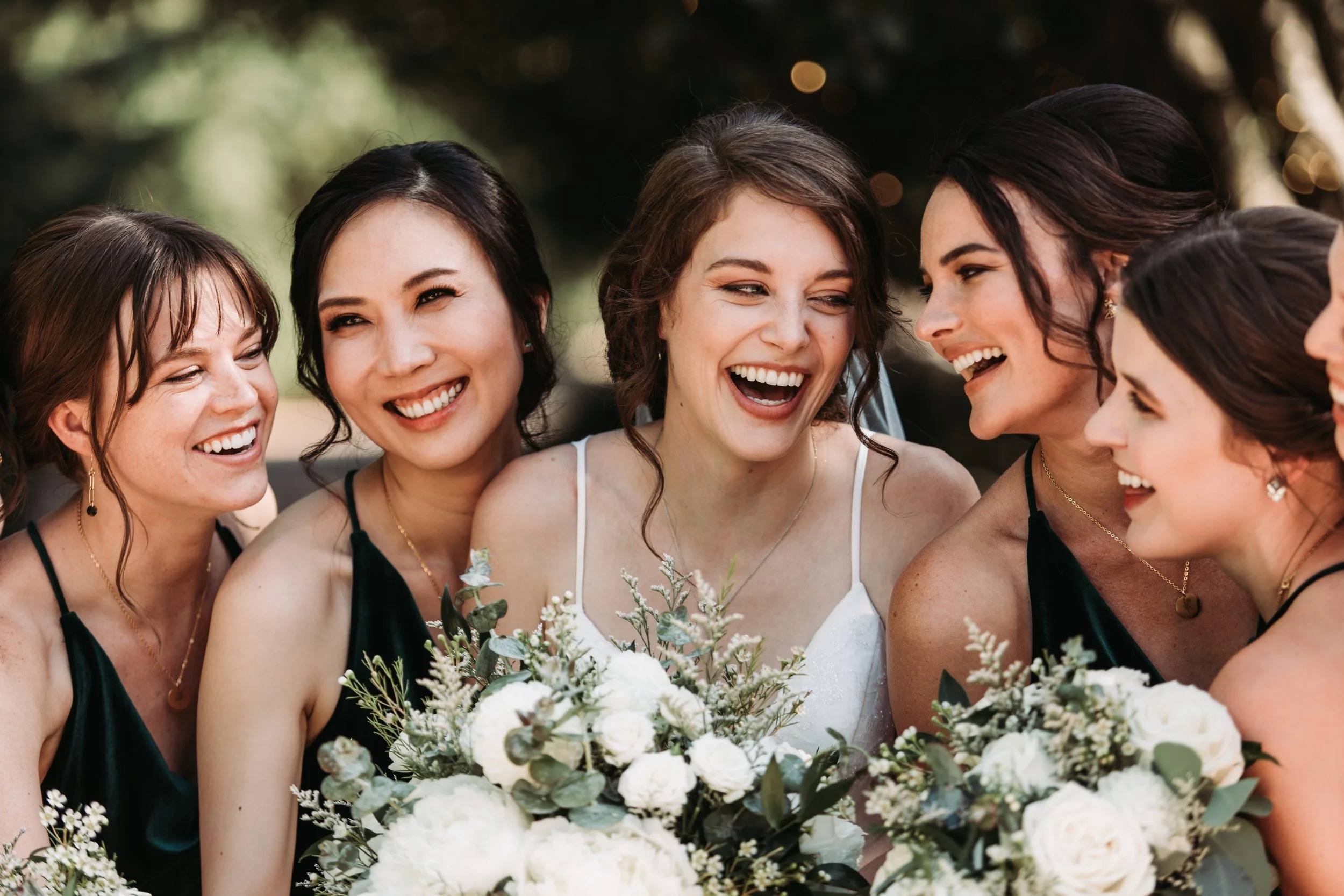 Radiant smiling bride celebrating with her bridal party