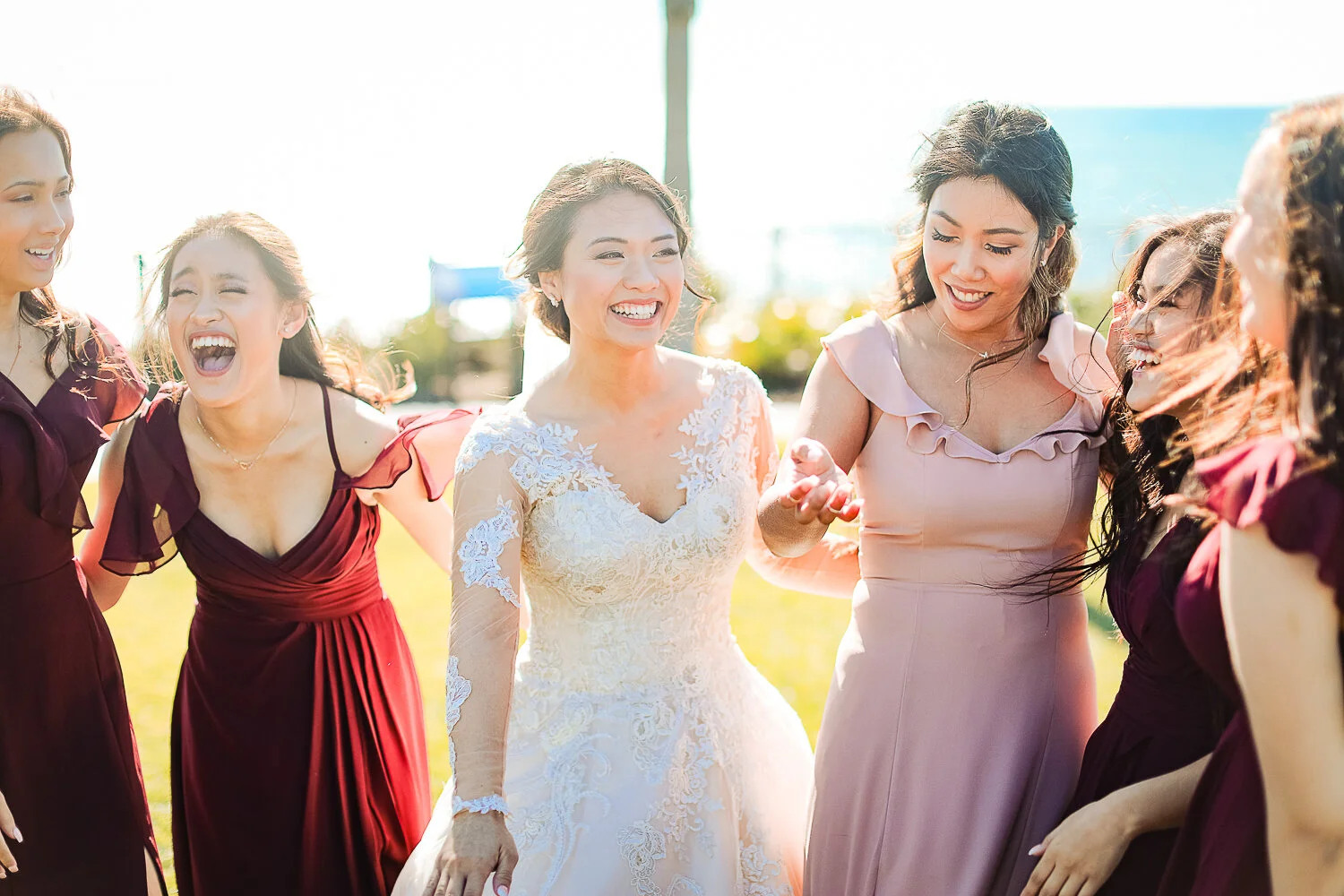 Joyful smiling bride laughing with her bridesmaids